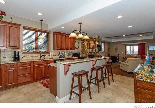 Modern kitchen with granite tops, microwave, oven/stove, lots of cabinets!