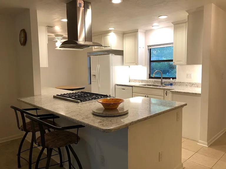 View of breakfast bar and into kitchen from living room