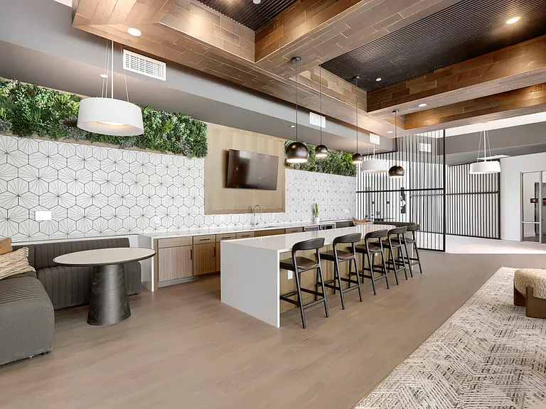 The social hub of Garrett Uptown. Our clubhouse kitchen and lounge features a full quartz-topped island, bar seating, a greenery wall, and a mounted TV, making it the perfect spot for watching the game or hosting neighbors.