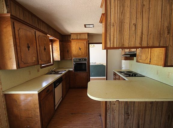 Kitchen has a range and dishwasher. 