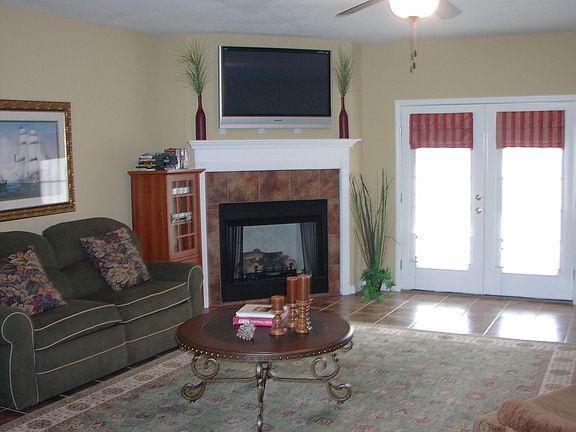 Large Great Room features corner fireplace and french doors onto patio