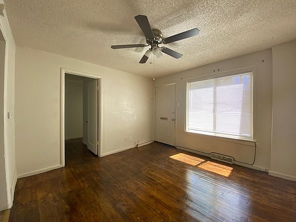 Living room looking toward front door and bedroom door.