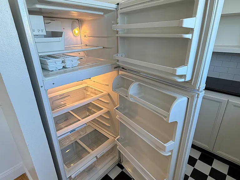 Full fridge and freezer with ice-maker.