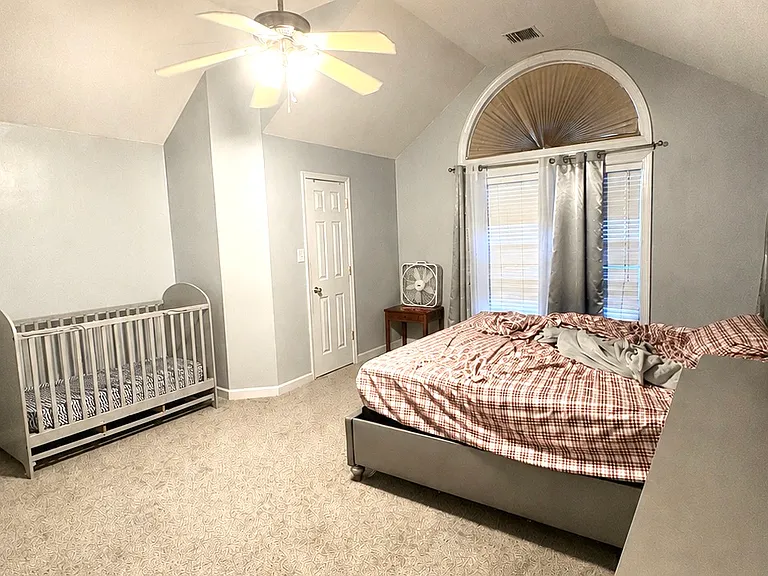 Primary bedroom with door to walk-in closet