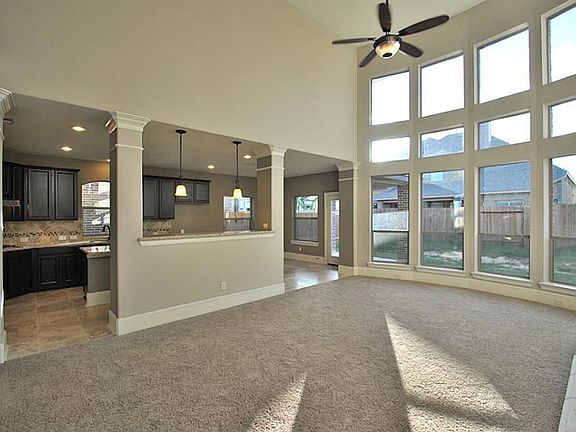 Family room open to gourmet kitchen 2 story high ceiling with lots of windows for natural light