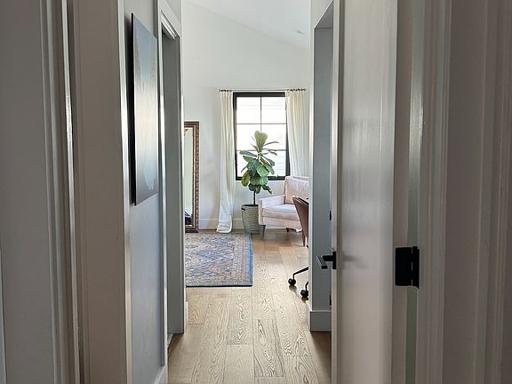 Hallway to master, walk in closet and bathroom on left, workout/office nook on right