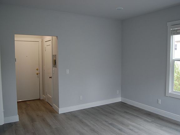 Bedroom/living room looking at exit to common hall & closet door