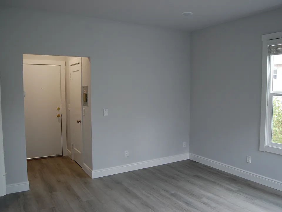 Bedroom/living room looking at exit to common hall & closet door
