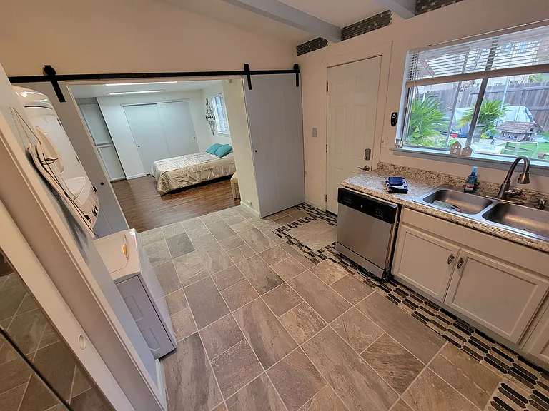 Kitchen W/ Barn DOORS OPEN TO ROOM