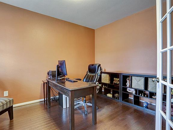 Beautiful study with hardwood floors, tall double glass doors, great in size, and located right off the front of the home!