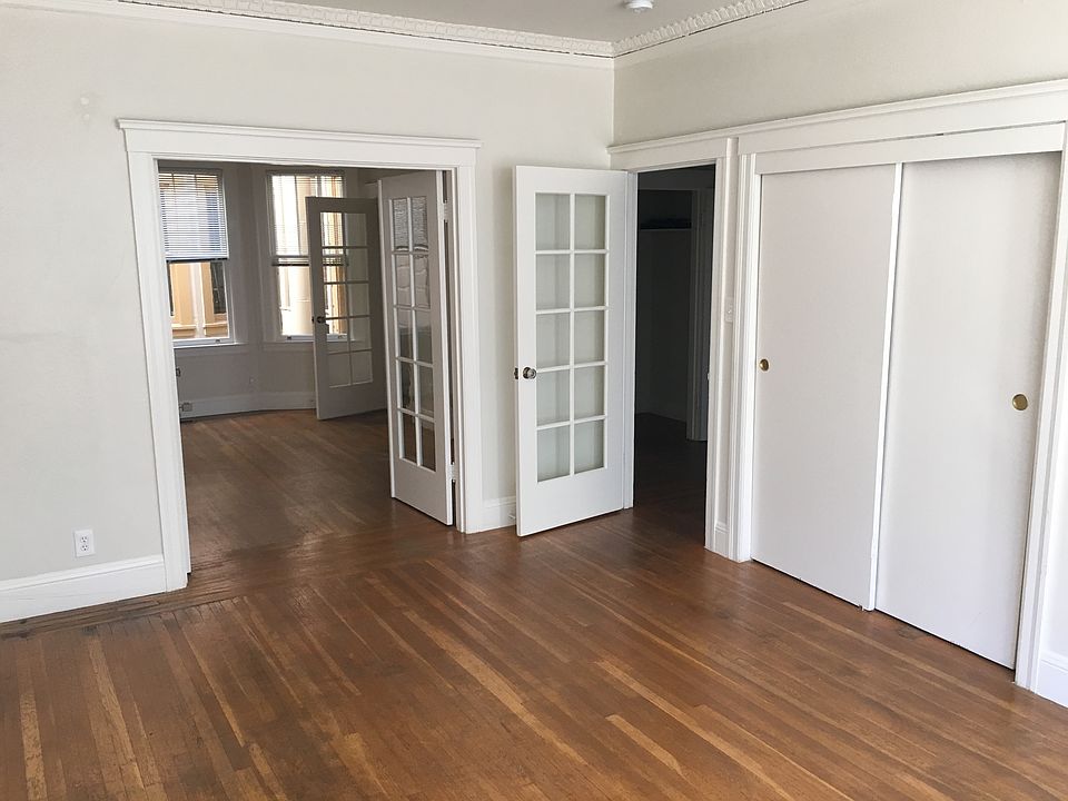 LR/BR with sliding door closet, doorways to BR/LR (left) and hallway (right)