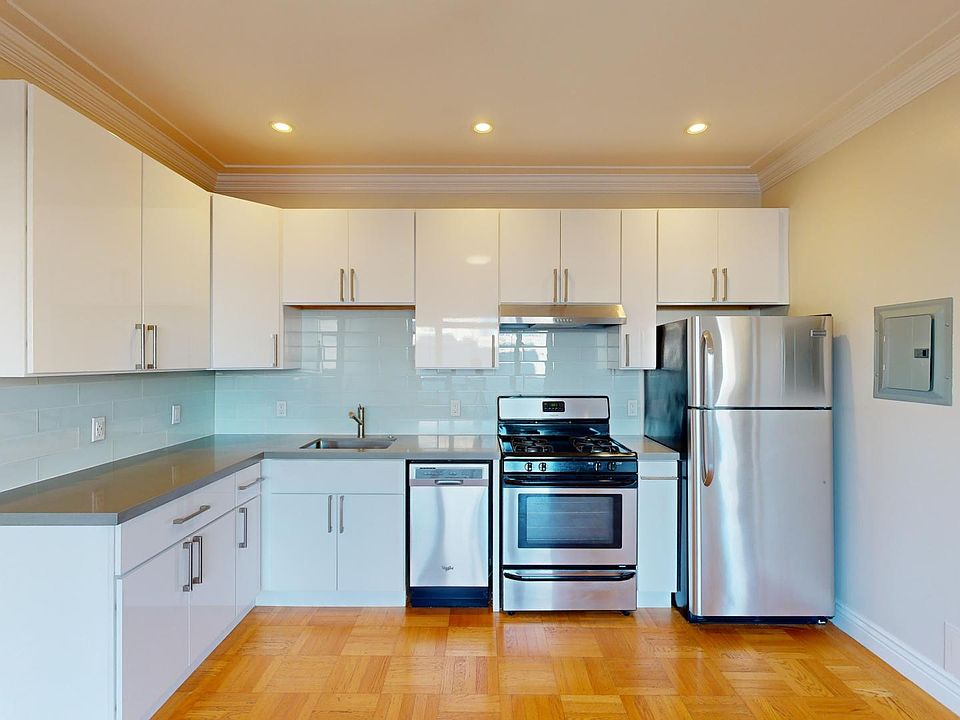 Modern kitchen featuring sleek cabinetry, stainless steel appliances, and a stylish countertop with backsplash.