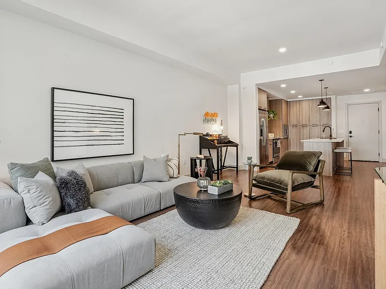 A serene, light-filled living space blending comfort and modern design with seamless access to the dining and kitchen areas.