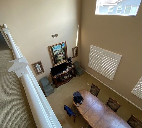 from upstairs looking into formal living and dining area used as school for home schoolers and students