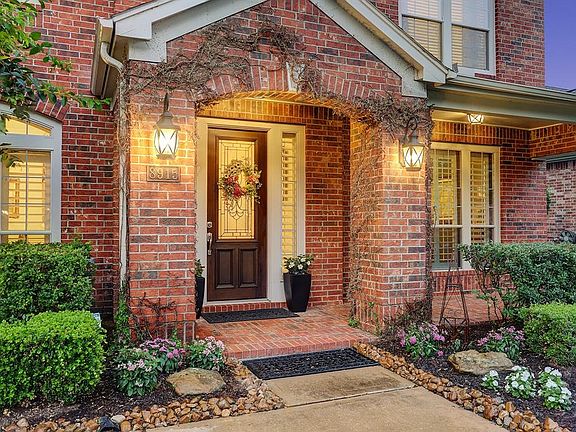 Your guests will enter through a charming covered brick porch with handsome coach lights surrounded by mature landscaping. Let's take a closer look inside. I promise, you will not be disappointed.