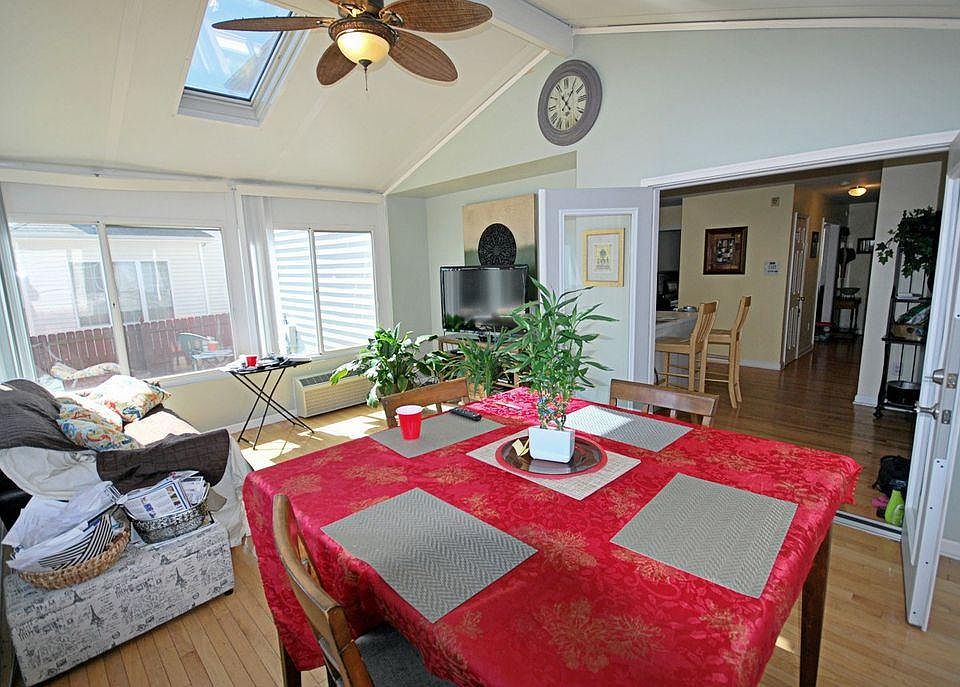 Here is a photo of the furnished four-season sunroom. All the windows open to let in plenty of natural light and fresh air, and the room can also be fully closed off for privacy or comfort. This room offers a clear view of the backyard.
