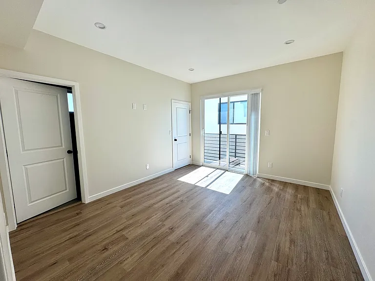 Master bedroom with walk in closet, small balcony and en suite bathroom