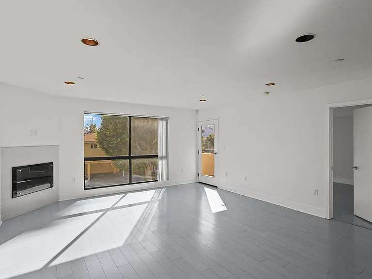 Bright & Spacious Living Room Area with Recessed Lighting and Vinyl Flooring