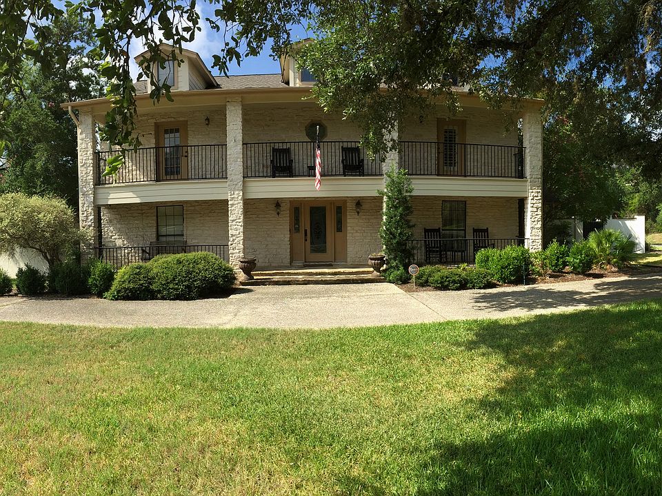 Front with half-circle driveway and gated garage