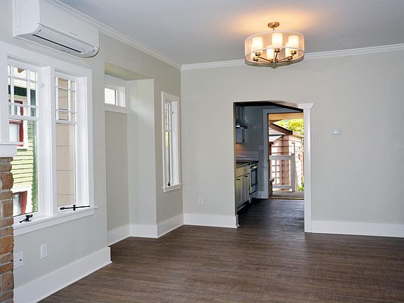 Large main living space with opening to kitchen.