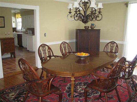 The formal dining room has polished hardwood floors, crown molding and chair r