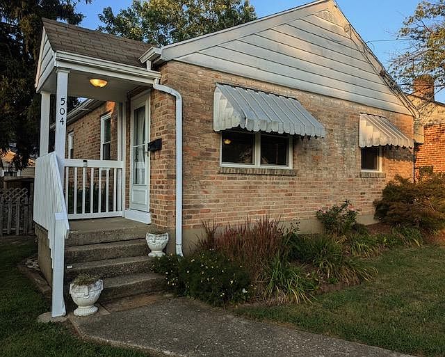 View of front porch and flower beds.