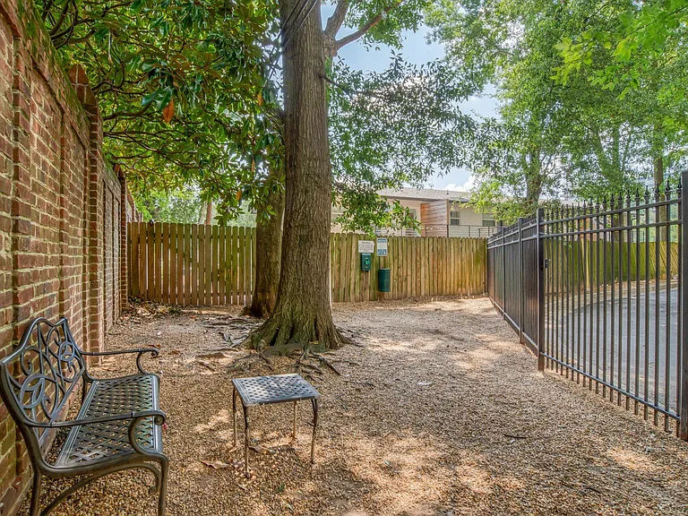 Fenced in dog area with benches