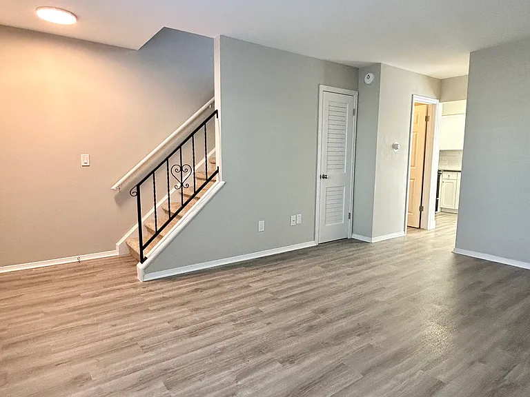 Step into a world of elegance with this open living area featuring a stylish staircase. Step into a world of elegance with this open living area featuring a stylish staircase.