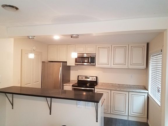 Open kitchen with Bar sitting looking out to Family room