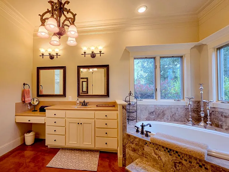 Primary bathroom with his/hers vanities, jetted tub, water closet, walk-in tiled shower and extra large closet. Complete privacy, no neighbors behind.