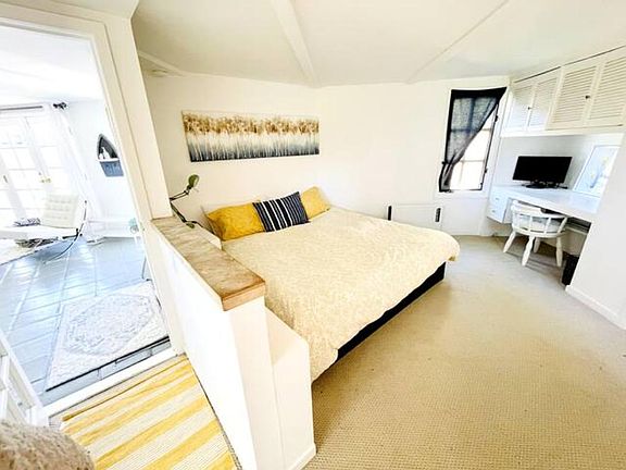 King size bed in bedroom with built-in desk