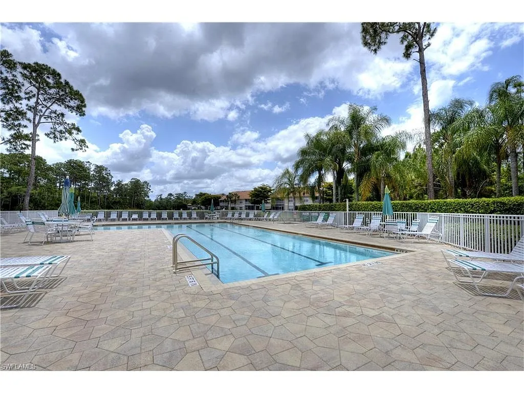 Community Pool & Hot Tub _ Enjoy a resort-style heated pool and relaxing hot tub, surrounded by lush tropical landscaping and ample lounge seating. The spacious sun deck offers plenty of room for sunbathing, reading, or unwinding under shaded umbrellas. - Sherborn Dr