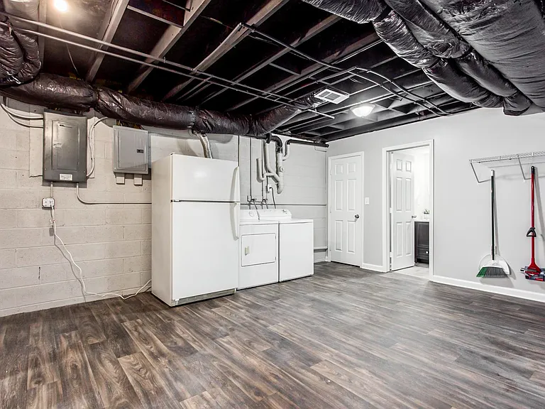 Downstairs laundry with additional fridge.