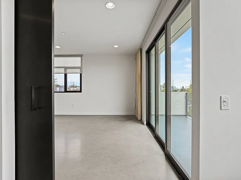 Bedroom Leading to Living Room with Patio and Lots of Natural Light