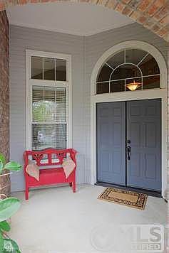 Grand double door covered entry.