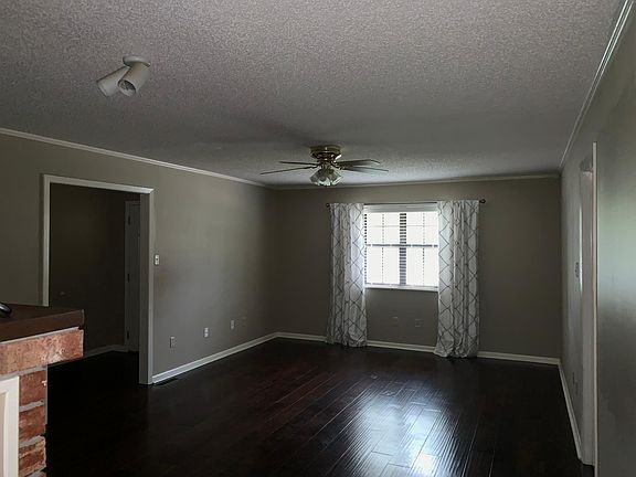 Large Living room with hand scraped hardwood floors and a ga
