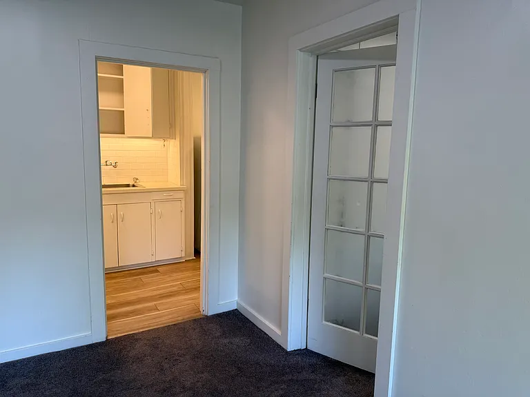 corner of LR with BR1 door and kitchen entry