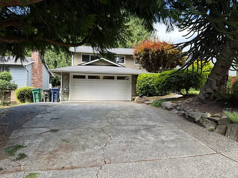 Front View of the House - shows the long driveway and the 2-car garage.