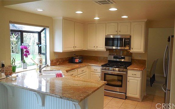 Gorgeous kitchen remodel! Features recessed lighting and breakfast bar!
