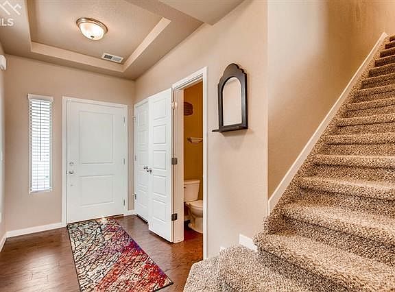 Beautiful entry-way with convenient powder bath and coat closet.