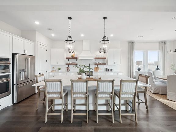 Kitchen with vaulted ceiling and pendant lighting