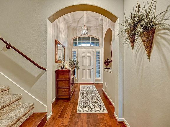 Dramatic foyer with warm floors and great arches.