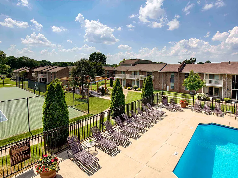 Aerial view of pool, sundeck, and tennis courts
