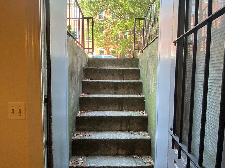 STREET TO SIDEWALK WITH A SECURITY LOCK GATE.