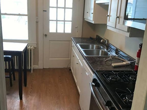 Kitchen leading to small back porch/balcony overlooking nice