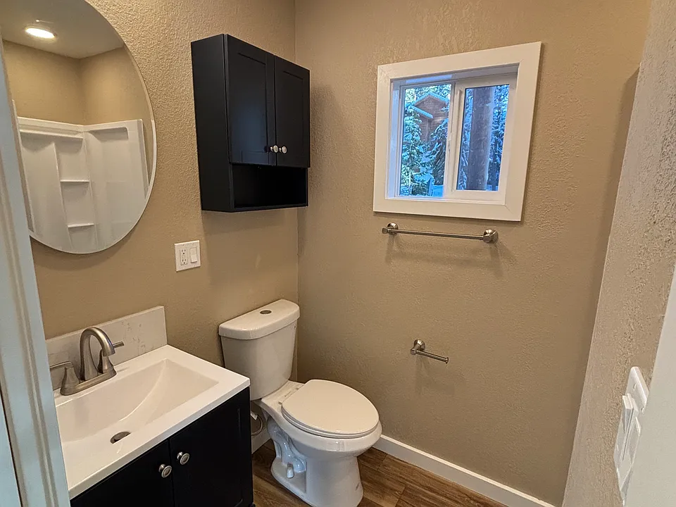 Brightly lit bathroom with fan