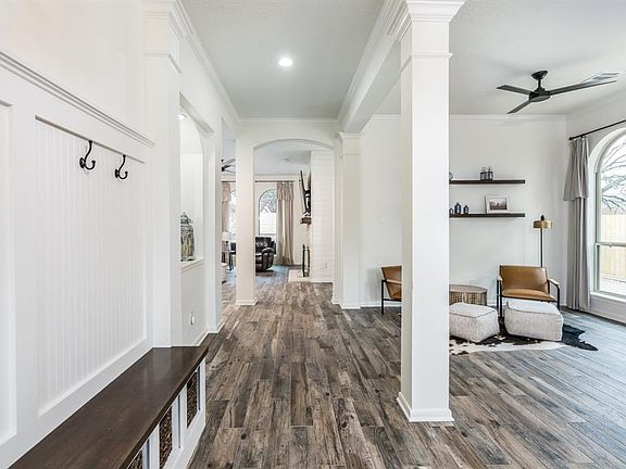 WOW! This home has been fabulously updated! Gorgeous wood tile flooring flows throughout the main living areas creating a seamless flow. Architectural details including arched walkways, columns and crown molding!