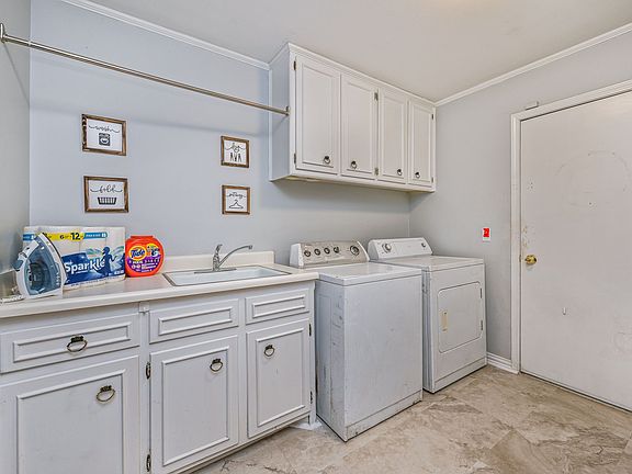 Full service laundry area with 2 storage closets