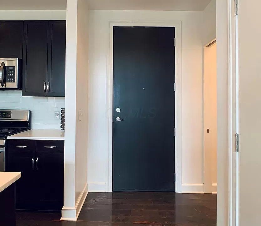 Condo Entryway- Kitchen(left), Entry to Half-Bath (right), Coat Closet (right).