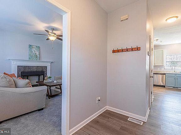 Entryway looking at the living room on the left and the kitchen down the hallway